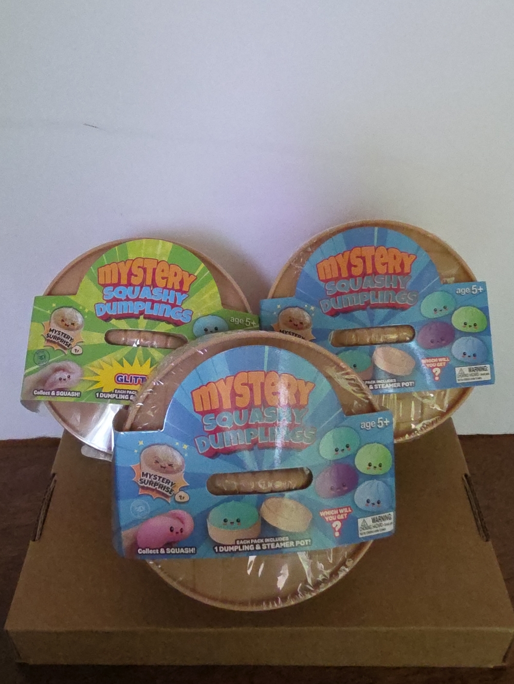 Mystery Squashy Dumplings Kids Toy - Tan Steamer Pot with Blue Packaging